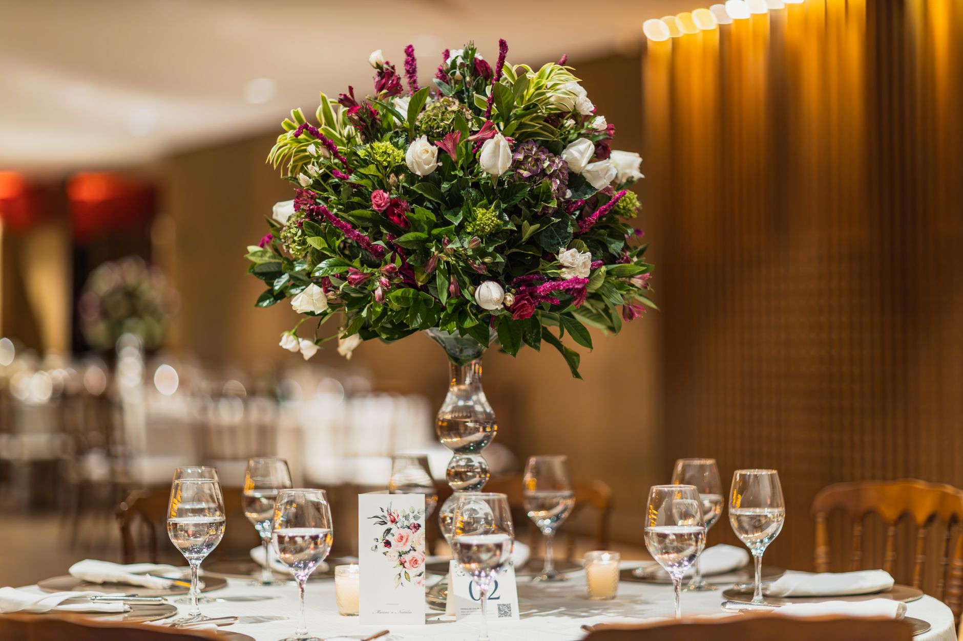A floral centerpiece on an elegantly set wedding table