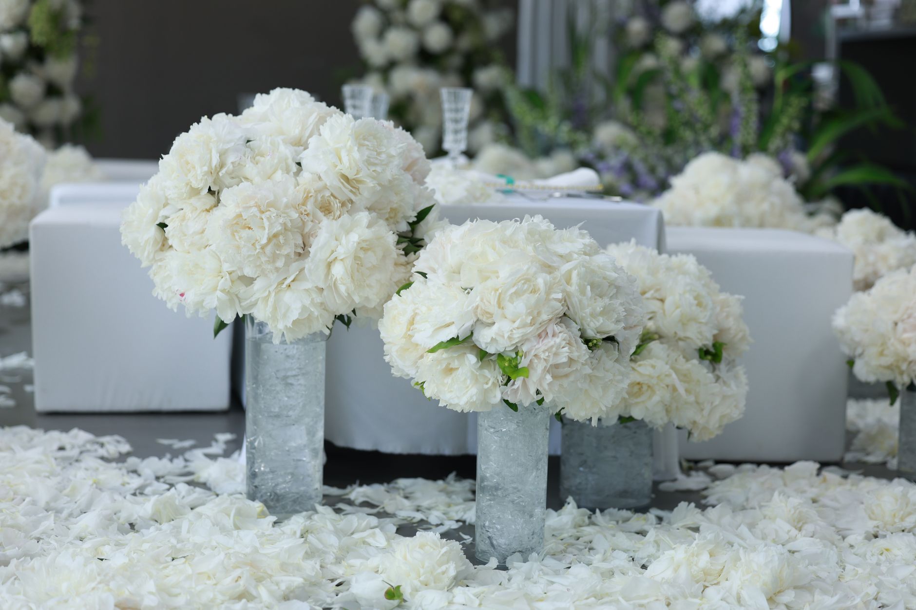 White wedding floral arrangements decorating a reception venue