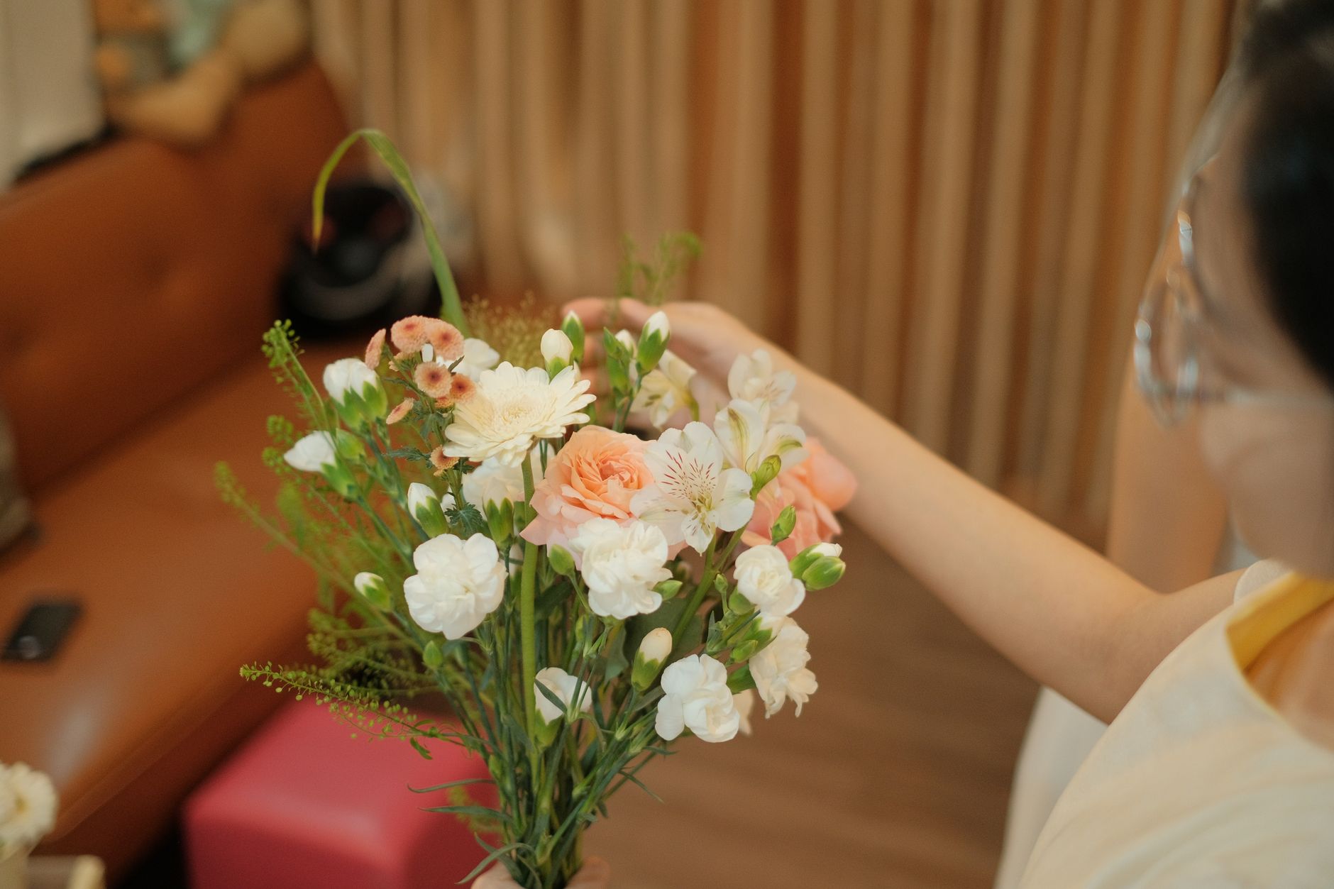 Florist arranging a colorful bouquet of flowers at a work table