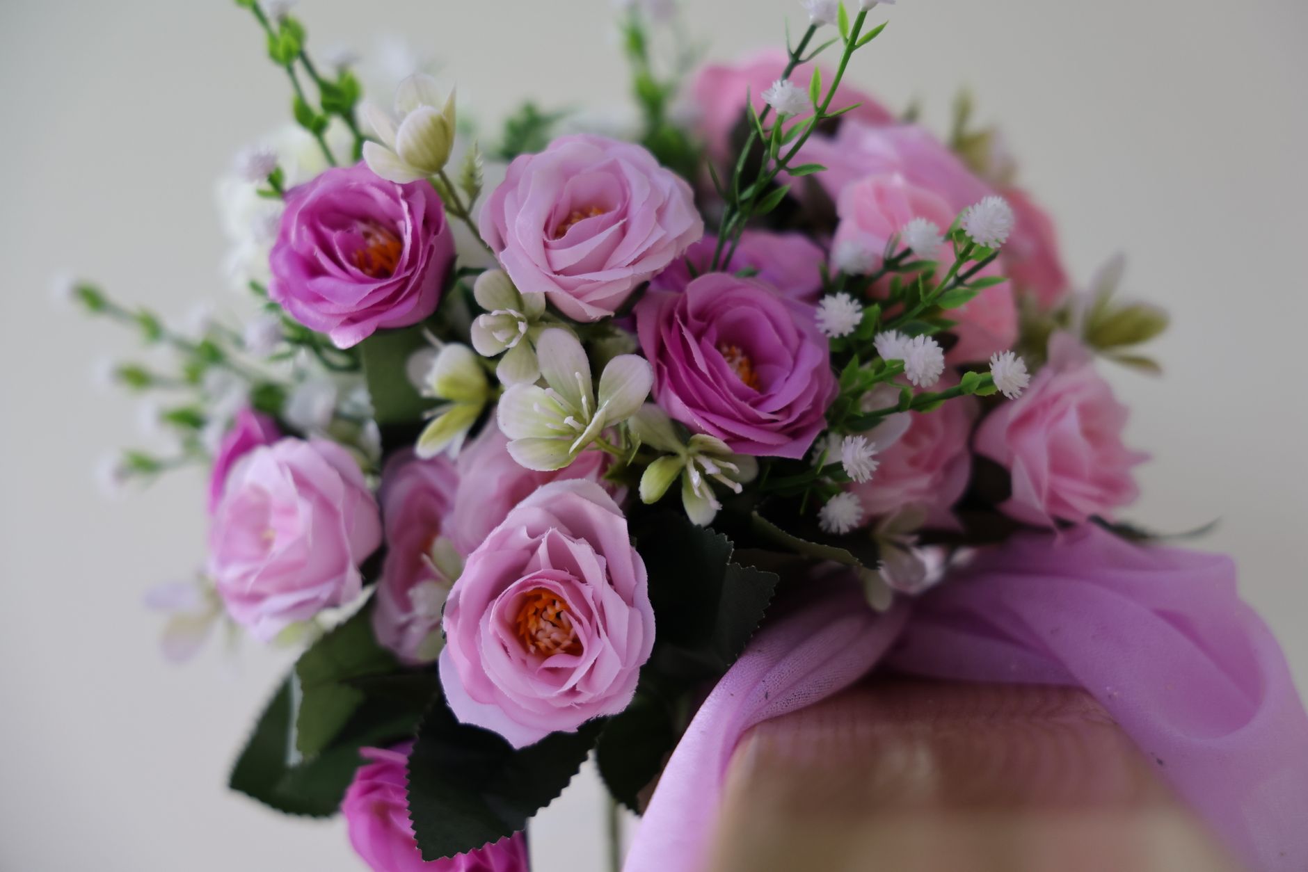 A fresh bouquet of pink roses and white flowers