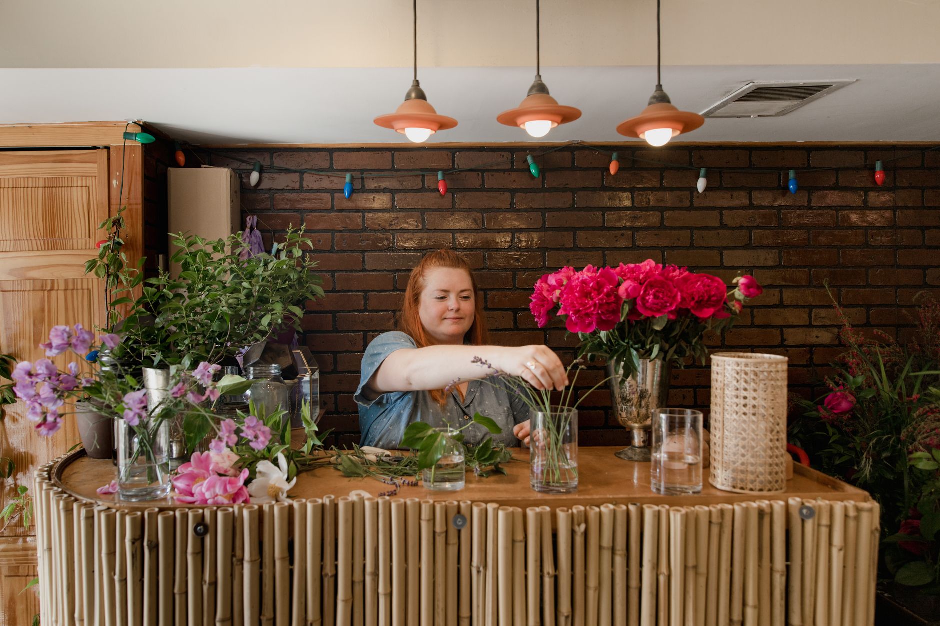 Florist arranging a vibrant bouquet inside a local flower shop